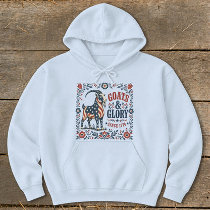 White hoodie with graphic of a goat adorned with the American flag, text "Goats & Glory Since 1776".