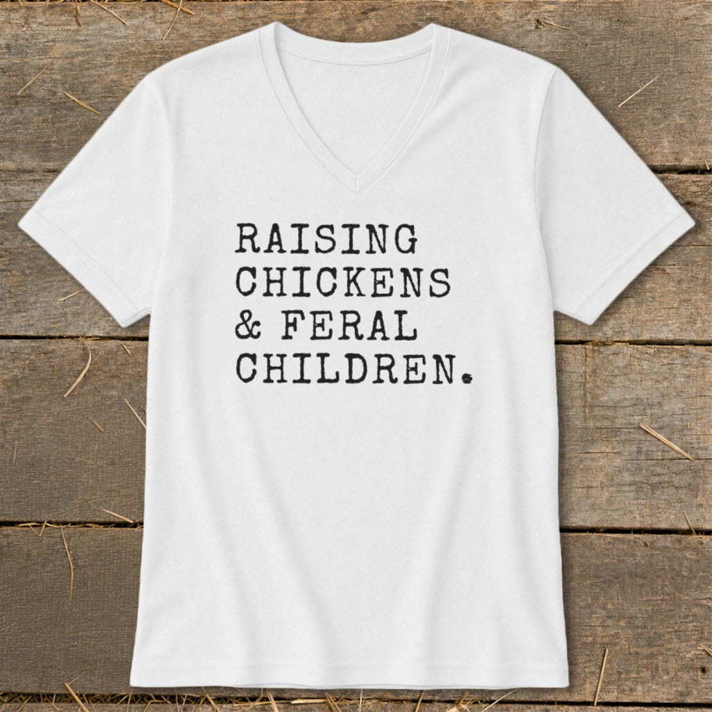 White V-neck t-shirt with black text reading "RAISING CHICKENS & FERAL CHILDREN."