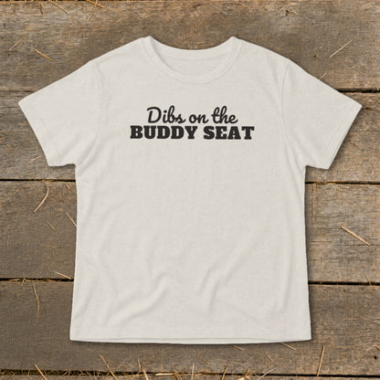 Light grey t-shirt with black text that reads "Dibs on the BUDDY SEAT".