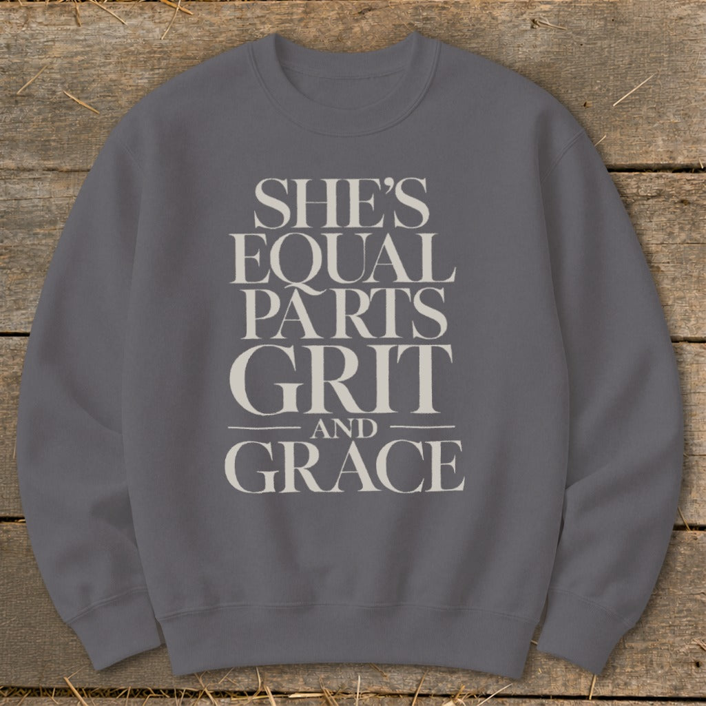 Gray sweatshirt with "She's Equal Parts Grit and Grace" text design.