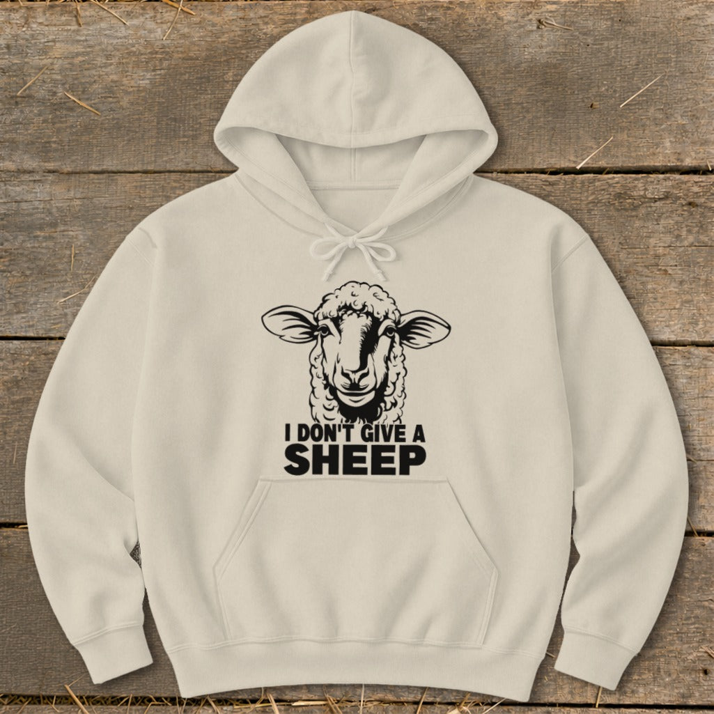 Cream hoodie with a black sheep graphic and text "I DON'T GIVE A SHEEP".