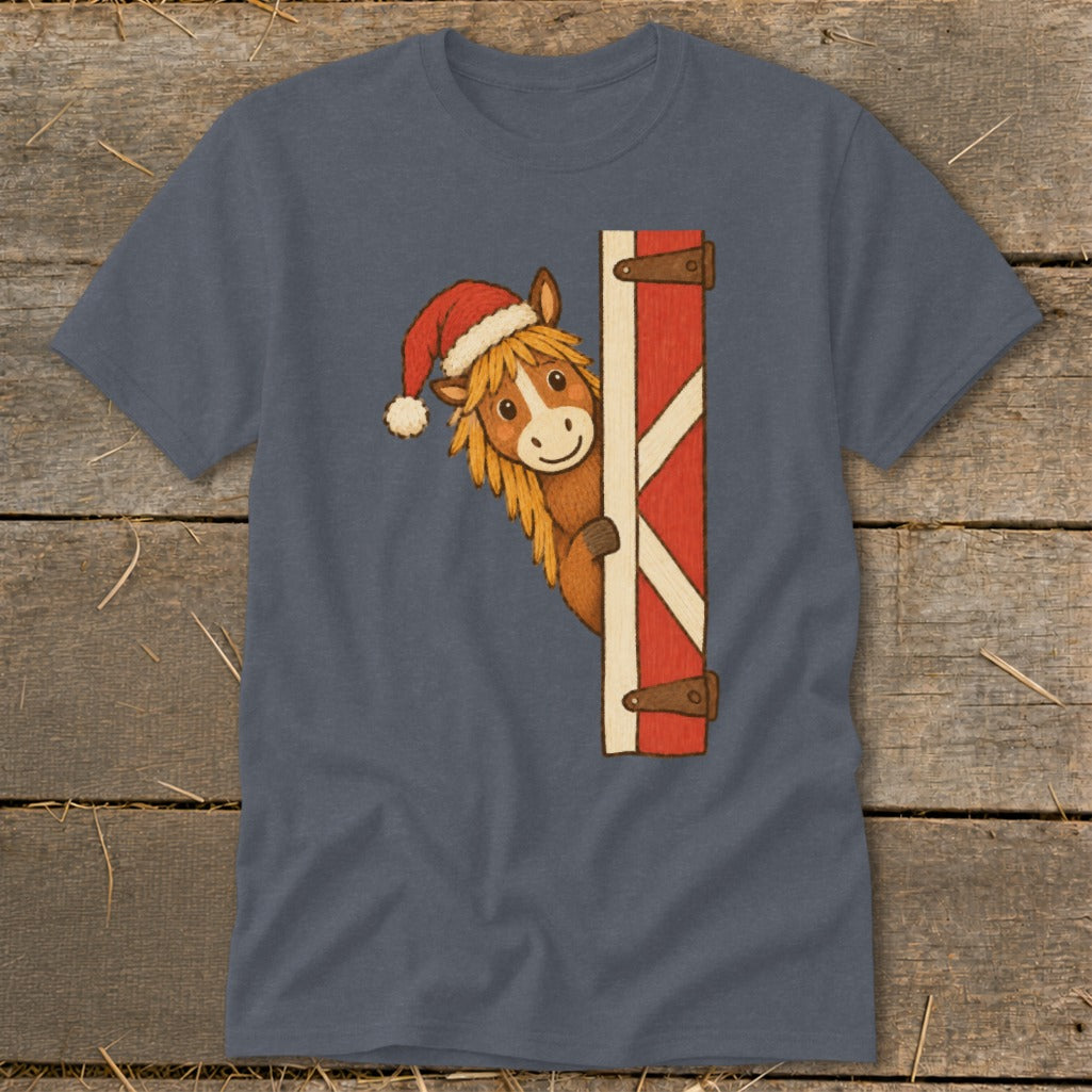 Horse wearing Santa hat peeking around a barn door.