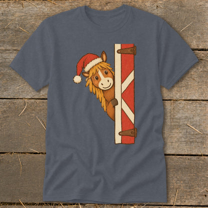 Horse wearing Santa hat peeking around a barn door.