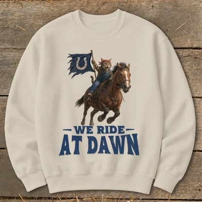 Cat riding a horse, holding a tattered flag with a horseshoe, text says "We Ride At Dawn."