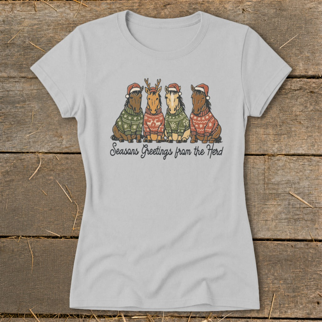 Four horses wearing Christmas sweaters and hats, with text "Seasons Greetings from the Herd."