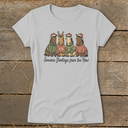 Four horses wearing Christmas sweaters and hats, with text "Seasons Greetings from the Herd."