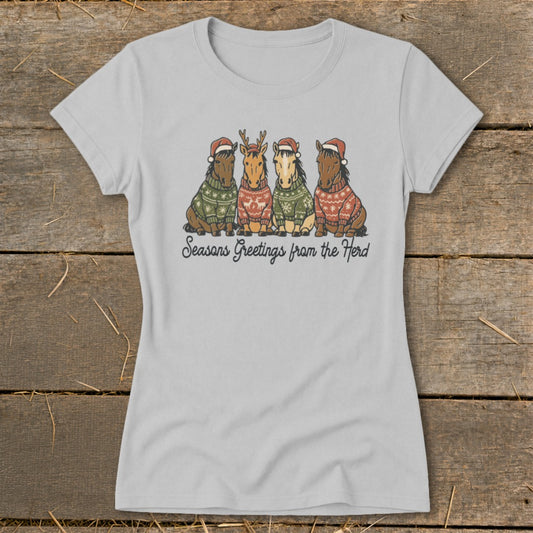 Four horses wearing Christmas sweaters and hats, with text "Seasons Greetings from the Herd."