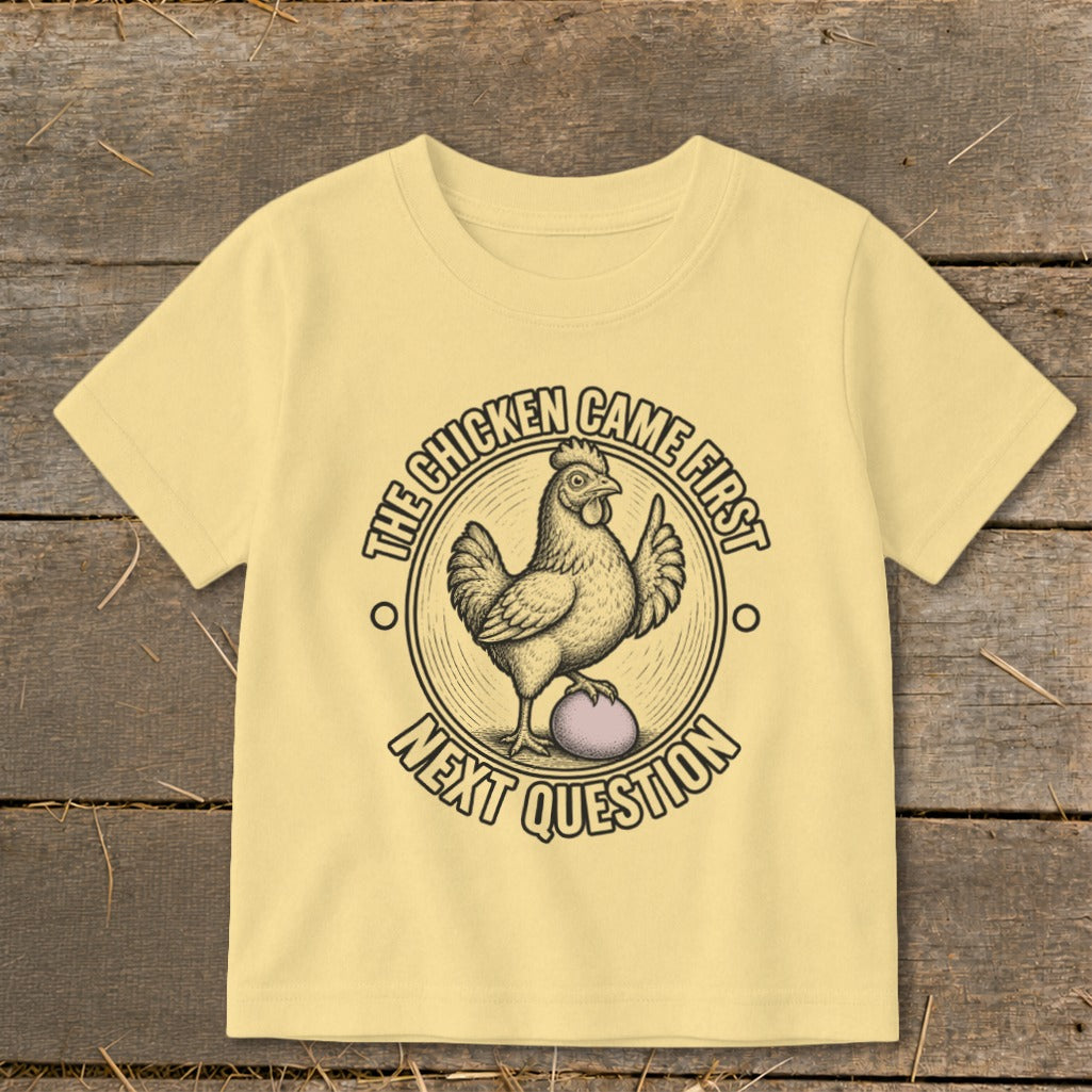 Yellow t-shirt with a chicken and egg graphic that reads "The Chicken Came First, Next Question".