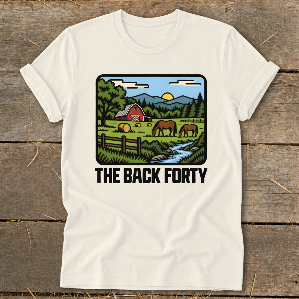 Off-white t-shirt with a vintage farm graphic and the text "The Back Forty" displayed on a wooden surface.