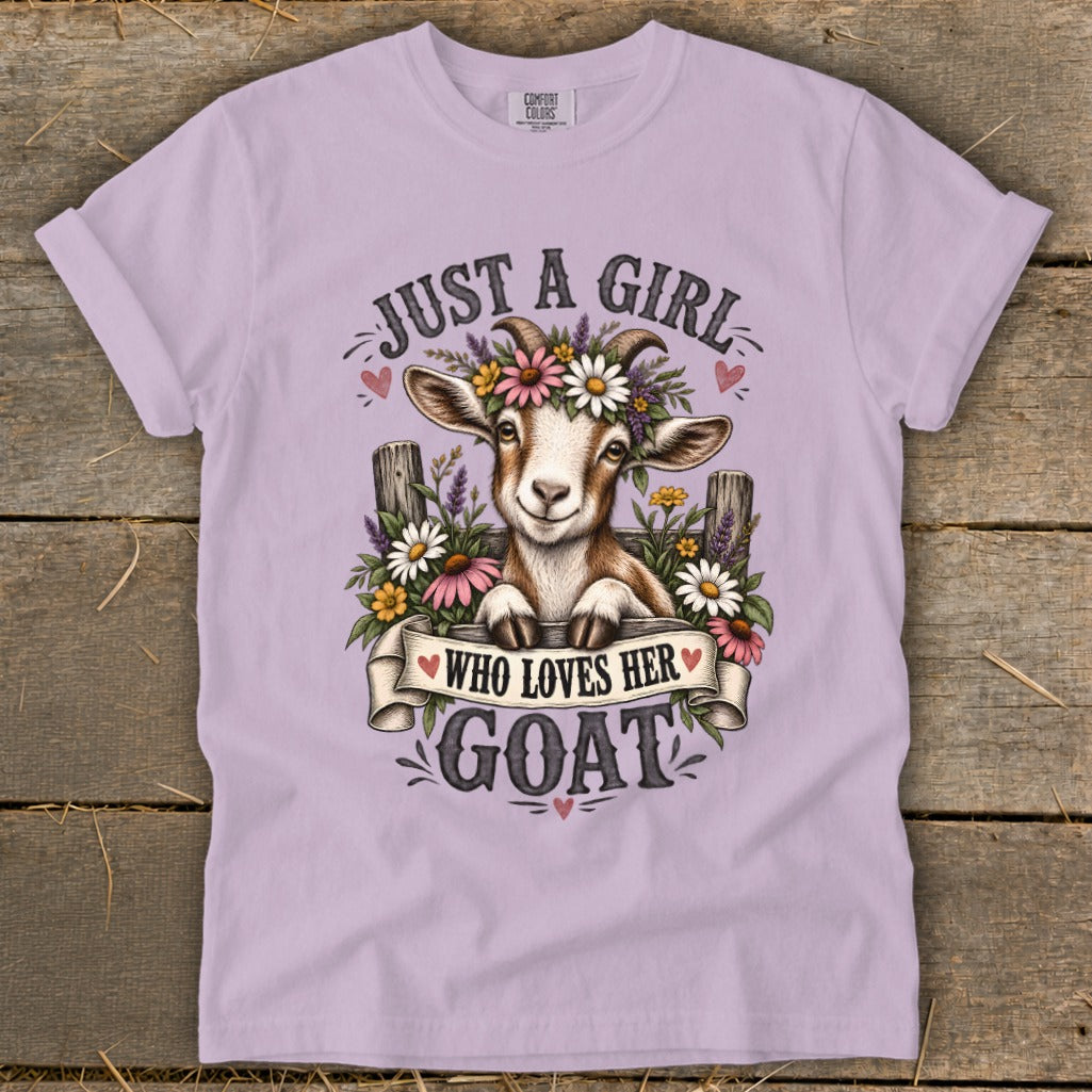 Lavender t-shirt with a goat wearing flowers and the text "Just a girl who loves her goat".