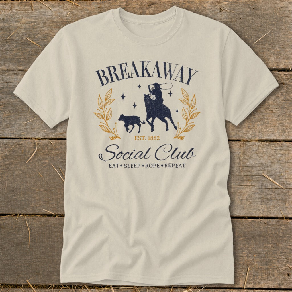 Cream t-shirt with "Breakaway Social Club" graphic featuring a cowboy roping a calf.