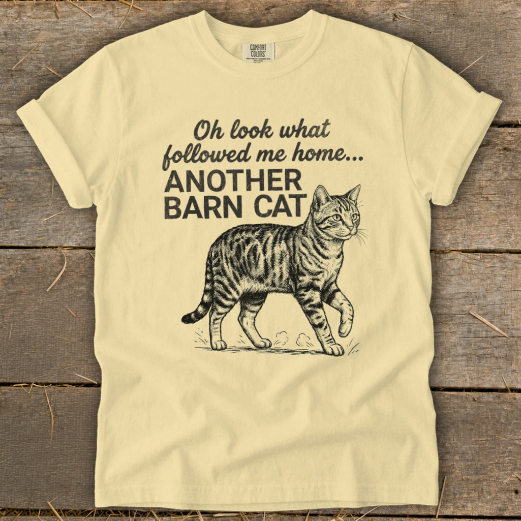 Light yellow t-shirt with "Oh look what followed me home... ANOTHER BARN CAT" text and a barn cat illustration.