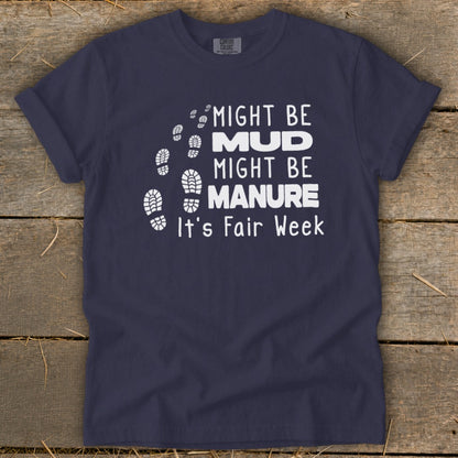 Navy t-shirt with white text: "Might be Mud, Might be Manure. It's Fair Week" and footprints.