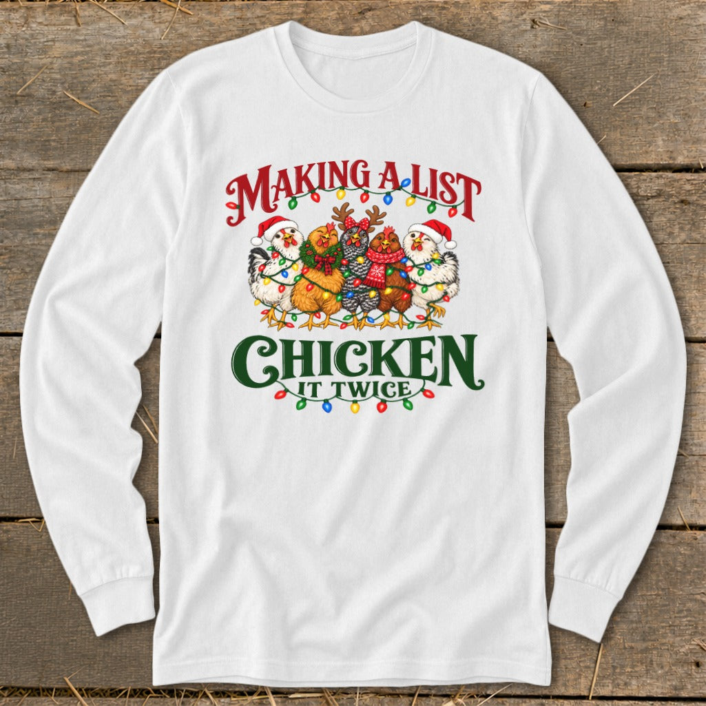 White long-sleeve shirt with chickens wearing Santa hats and Christmas lights, reading "Making a list, chicken it twice."