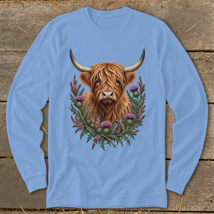 Long-sleeved blue shirt with Highland cow and thistles design.