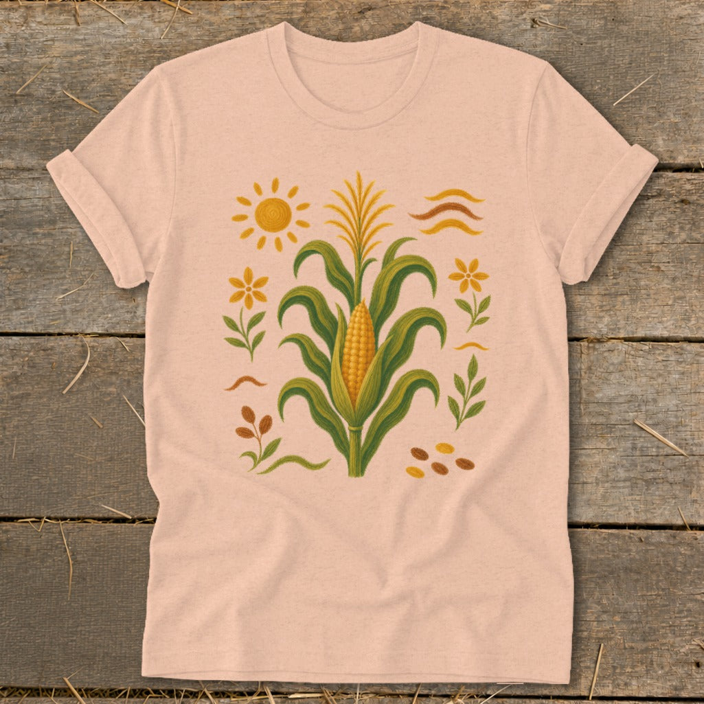 Peach t-shirt with corn stalk, sun, and flower graphic.
