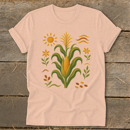 Peach t-shirt with corn stalk, sun, and flower graphic.