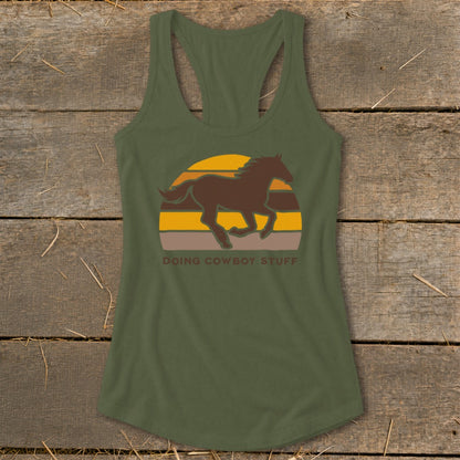 Green tank top with a brown horse graphic and "DOING COWBOY STUFF" text.