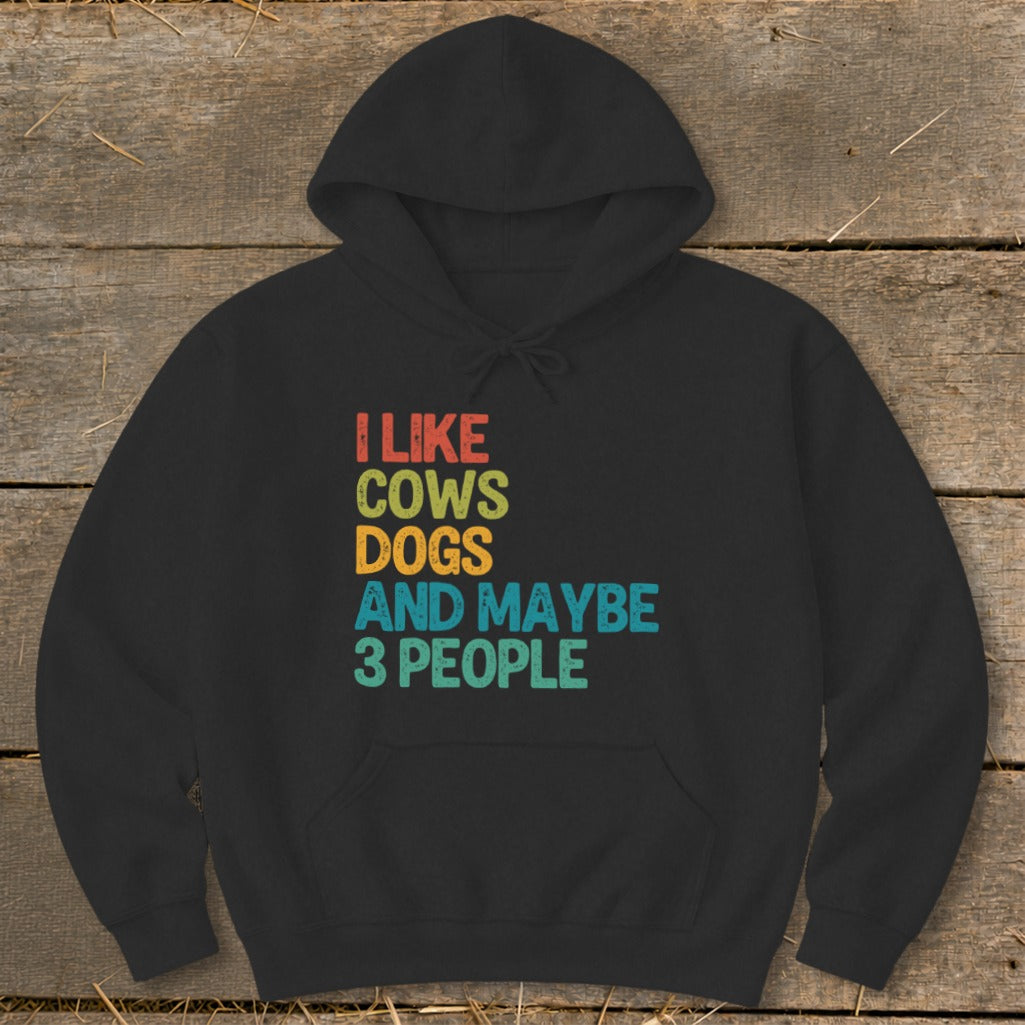 Black hoodie with text "I LIKE COWS DOGS AND MAYBE 3 PEOPLE".