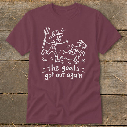 Maroon t-shirt with white cartoon of a farmer chasing goats and text "the goats got out again."