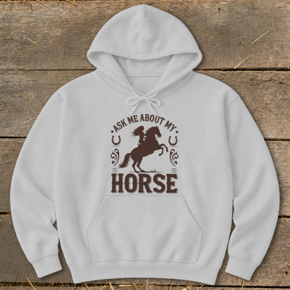White hoodie with brown graphic of a rider on a horse and text "Ask me about my horse".