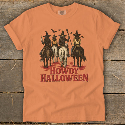 Orange t-shirt with four witches on horses and "HOWDY HALLOWEEN" text.