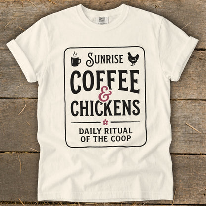 White t-shirt with black text: "Sunrise Coffee & Chickens Daily Ritual of the Coop".