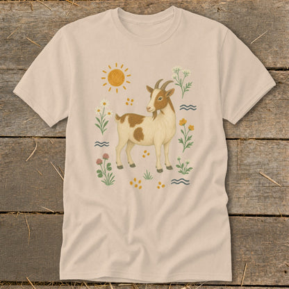 T-shirt with a tan background featuring a tan and white goat surrounded by flowers and the sun.