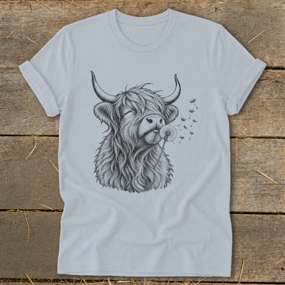 Highland cow blowing dandelion seeds on a light blue t-shirt.