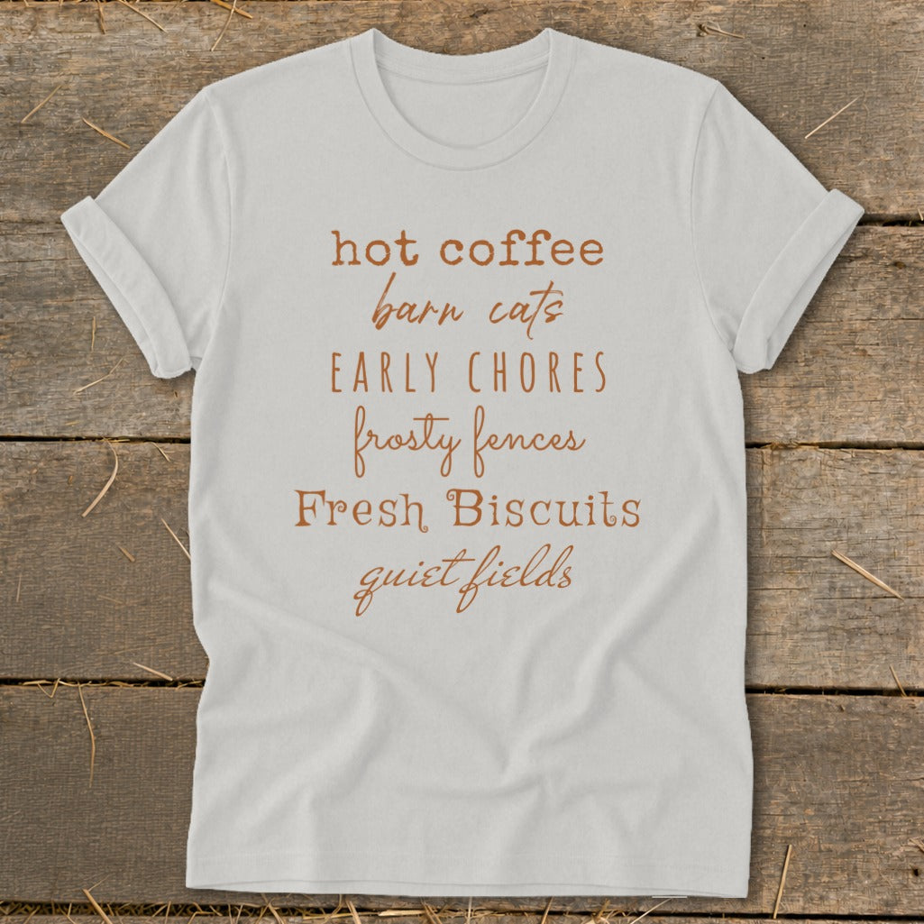 White t-shirt with text: hot coffee, barn cats, EARLY CHORES, frosty fences, Fresh Biscuits, quiet fields.
