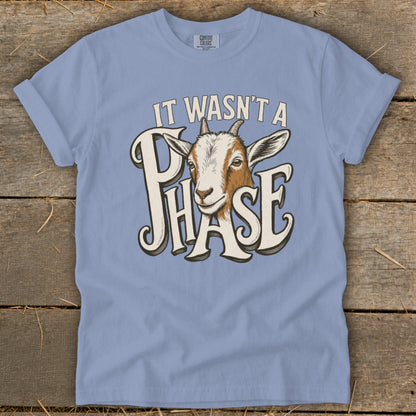 Light blue t-shirt with a graphic of a goat and text that reads "IT WASN'T A PHASE".