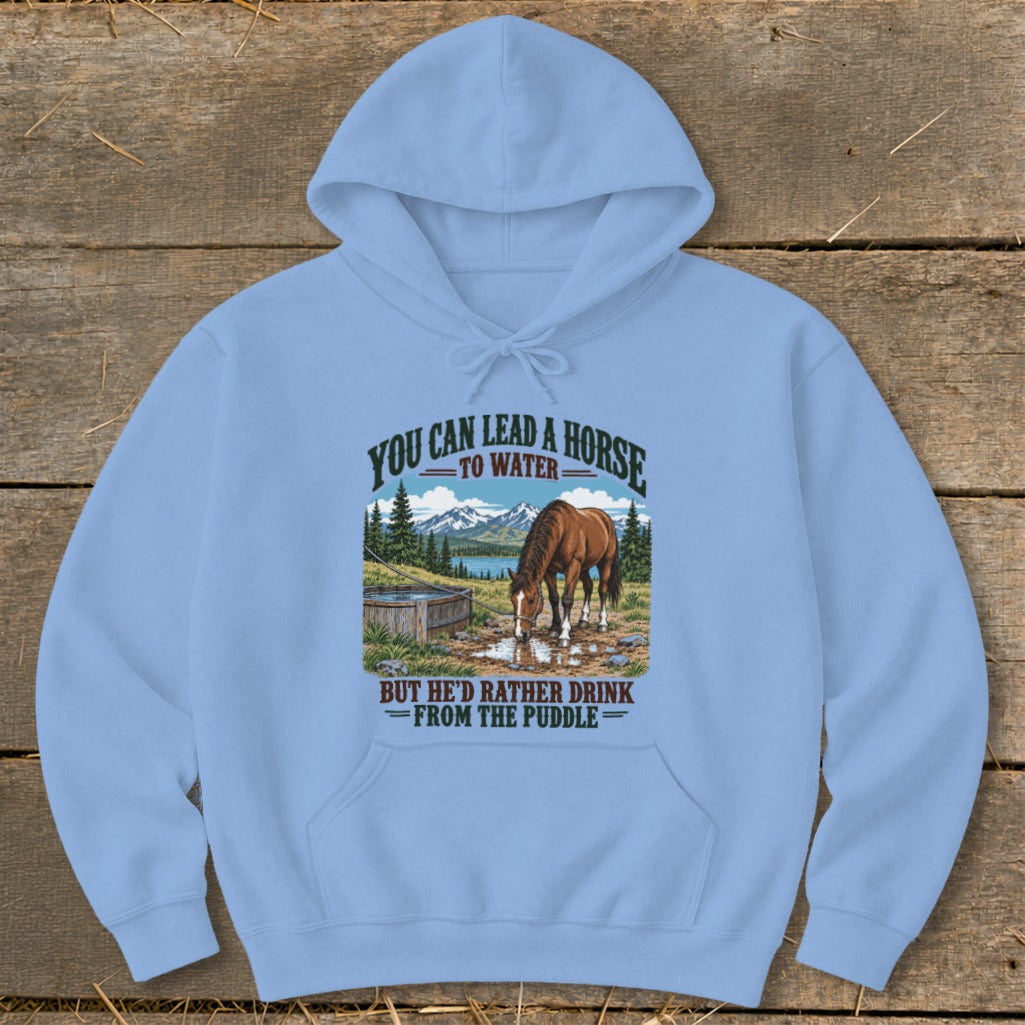A light blue hooded sweatshirt features a graphic of a horse drinking from a puddle with text above and below.