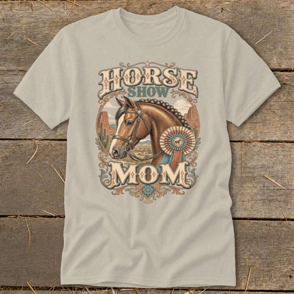 Horse Show Mom graphic on a light brown t-shirt with a horse, award ribbon, and desert background.