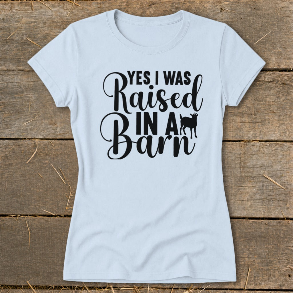 Light blue t-shirt with black text "YES I WAS Raised IN A Barn" and a goat silhouette.