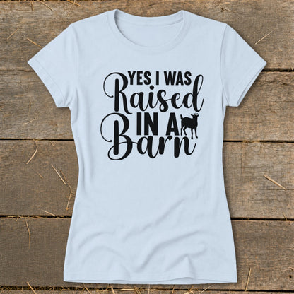 Light blue t-shirt with black text "YES I WAS Raised IN A Barn" and a goat silhouette.