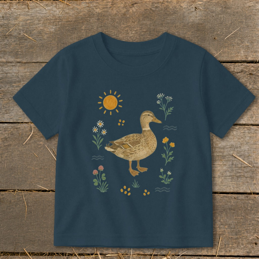 Navy t-shirt with a duck illustration surrounded by flowers and a sun.