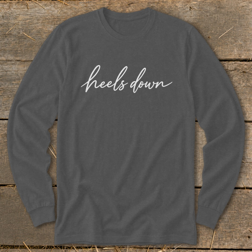 Charcoal long-sleeve shirt with white "heels down" text