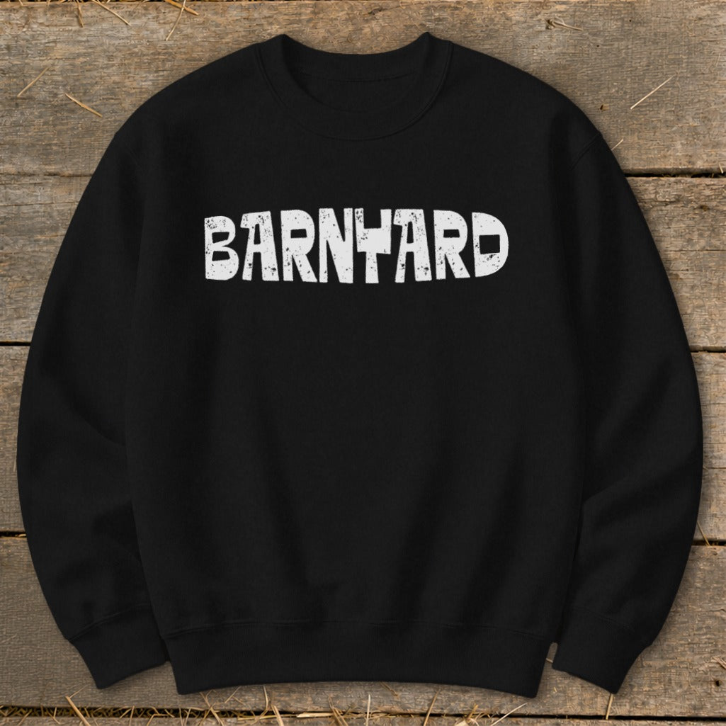 A black crewneck sweatshirt features distressed white text across the chest that spells out BARNYARD.