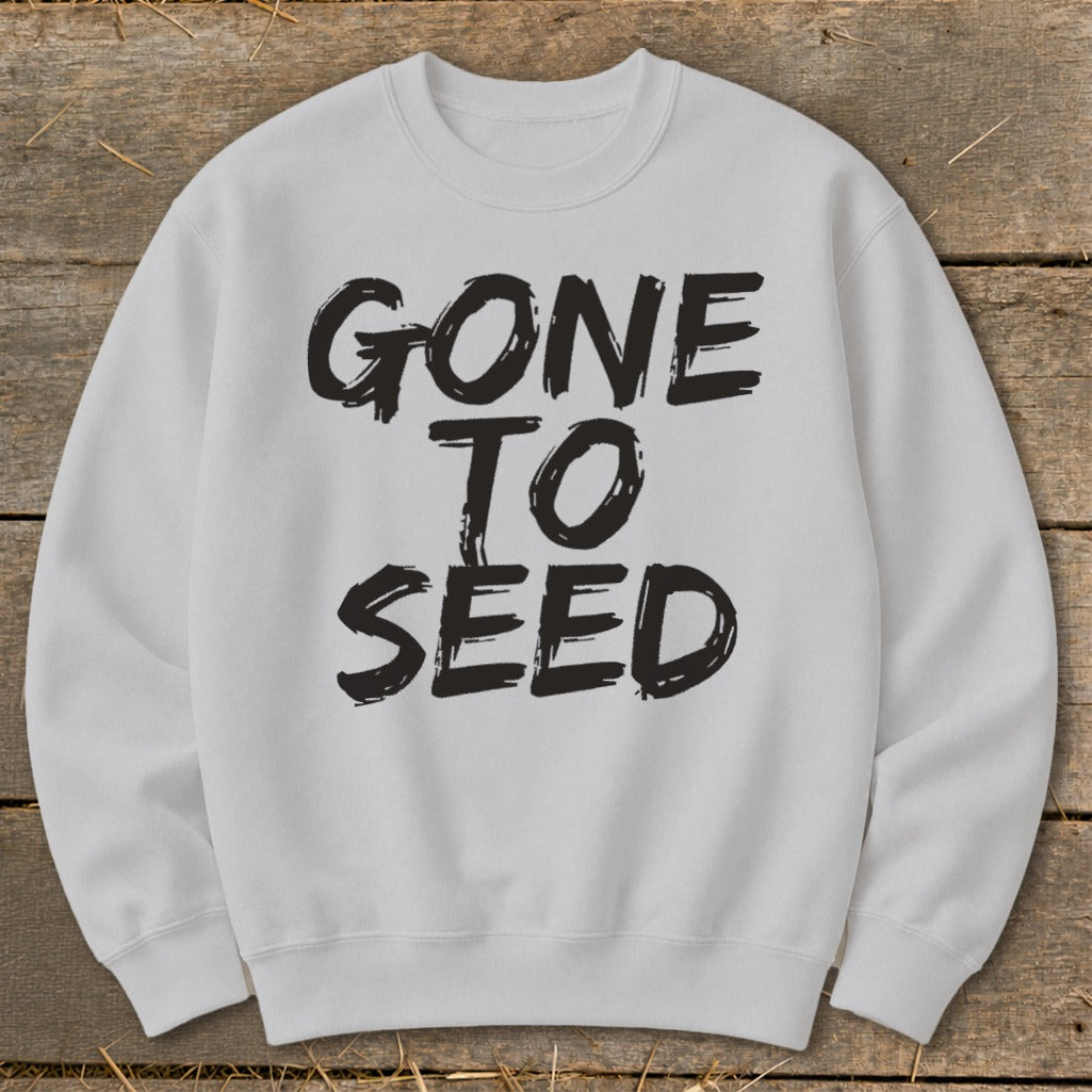 Light grey sweatshirt with black brushstroke text "GONE TO SEED".