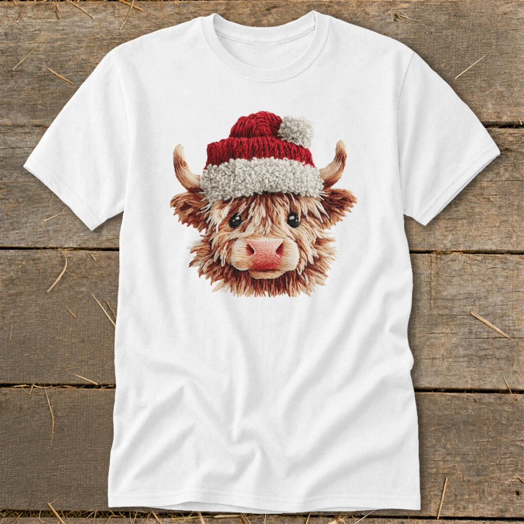 White t-shirt featuring a fluffy Highland cow wearing a Santa hat.