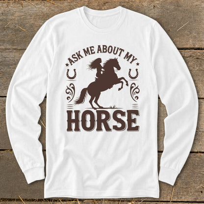 White long-sleeve shirt with brown graphic: "Ask Me About My Horse" with a rider on a rearing horse.