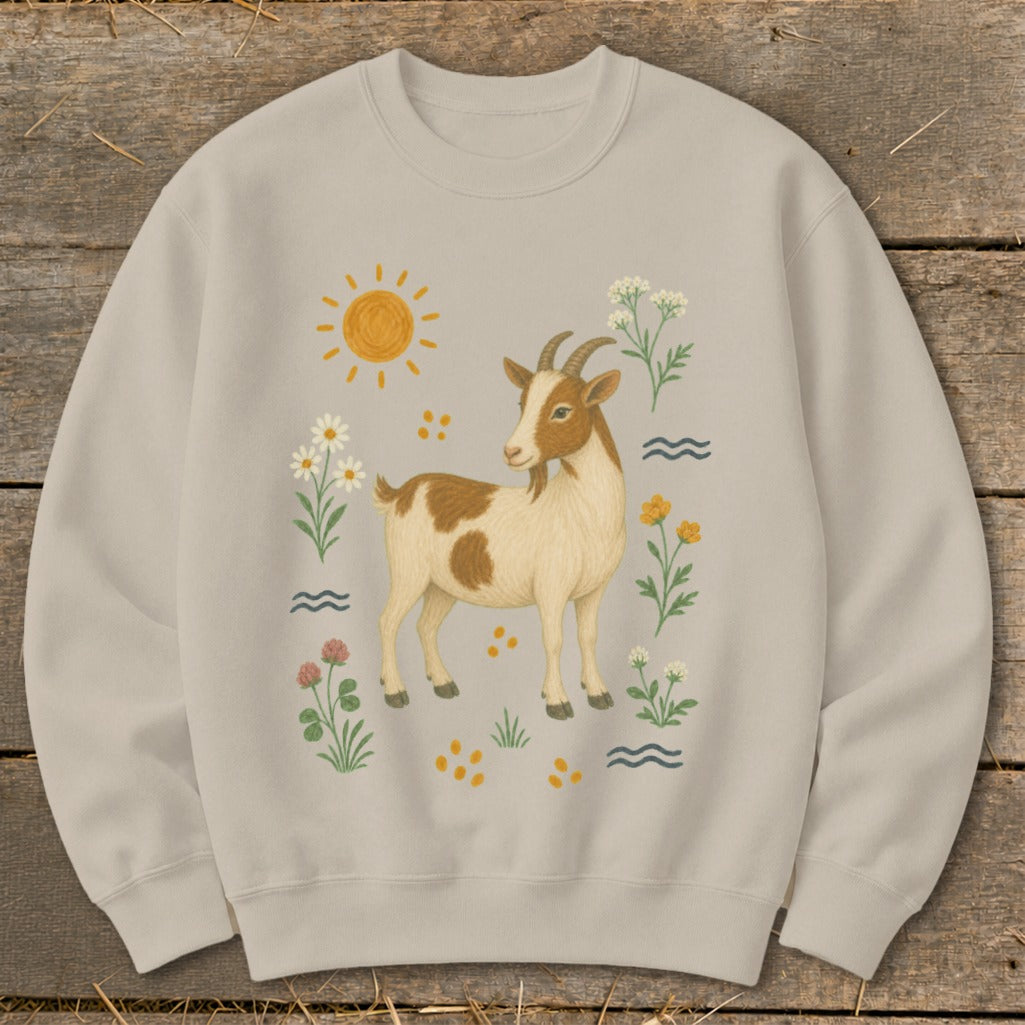 Light beige sweatshirt with a tan and white goat surrounded by flowers and a sun.