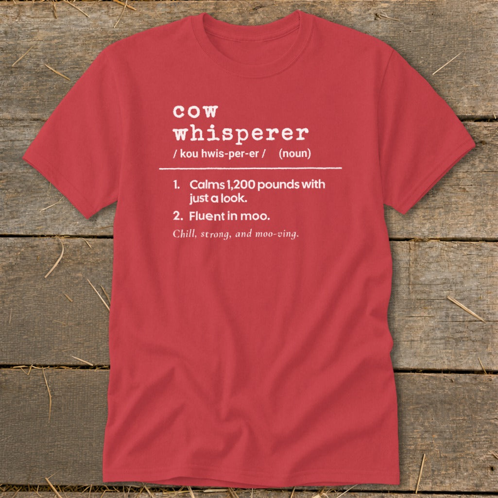 Red t-shirt with "cow whisperer" definition: calms 1,200 pounds, fluent in moo.