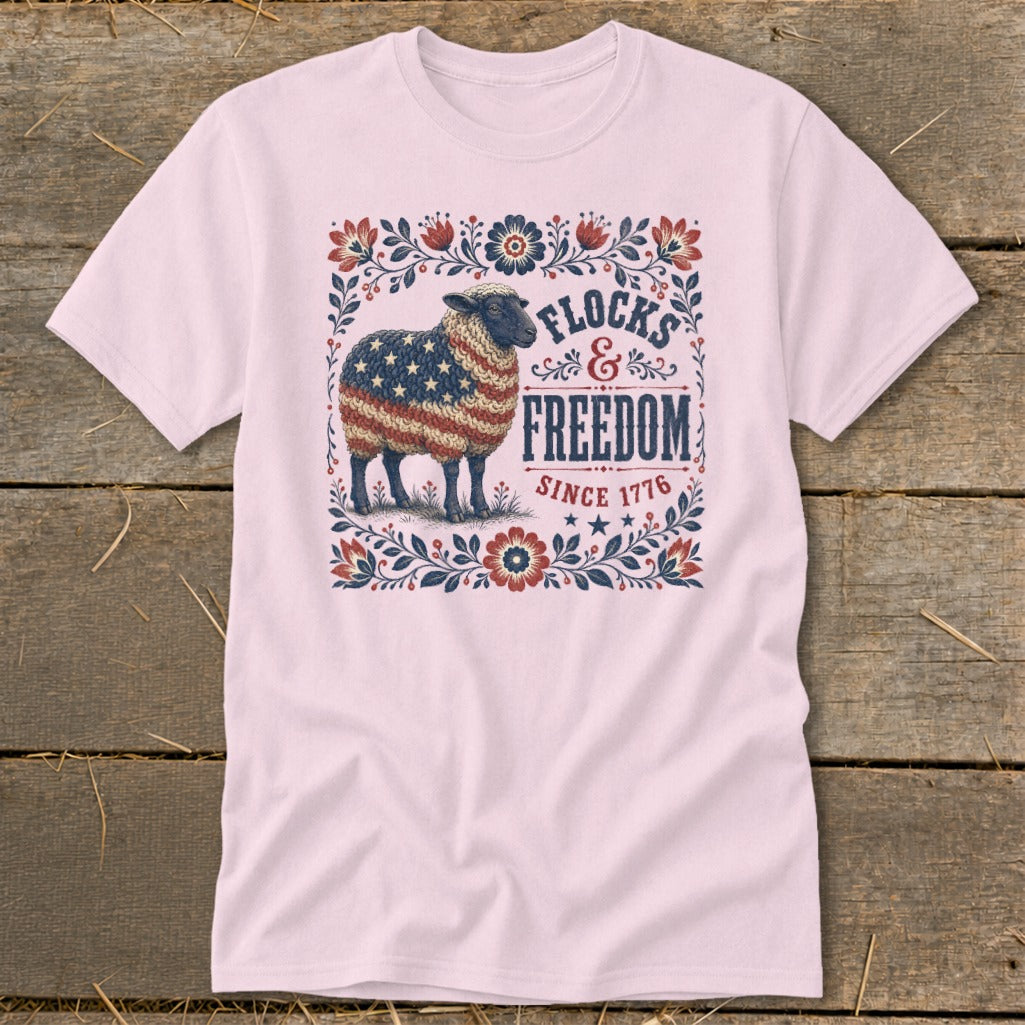Pink t-shirt with sheep in American flag wool, text reads "Flocks & Freedom Since 1776".