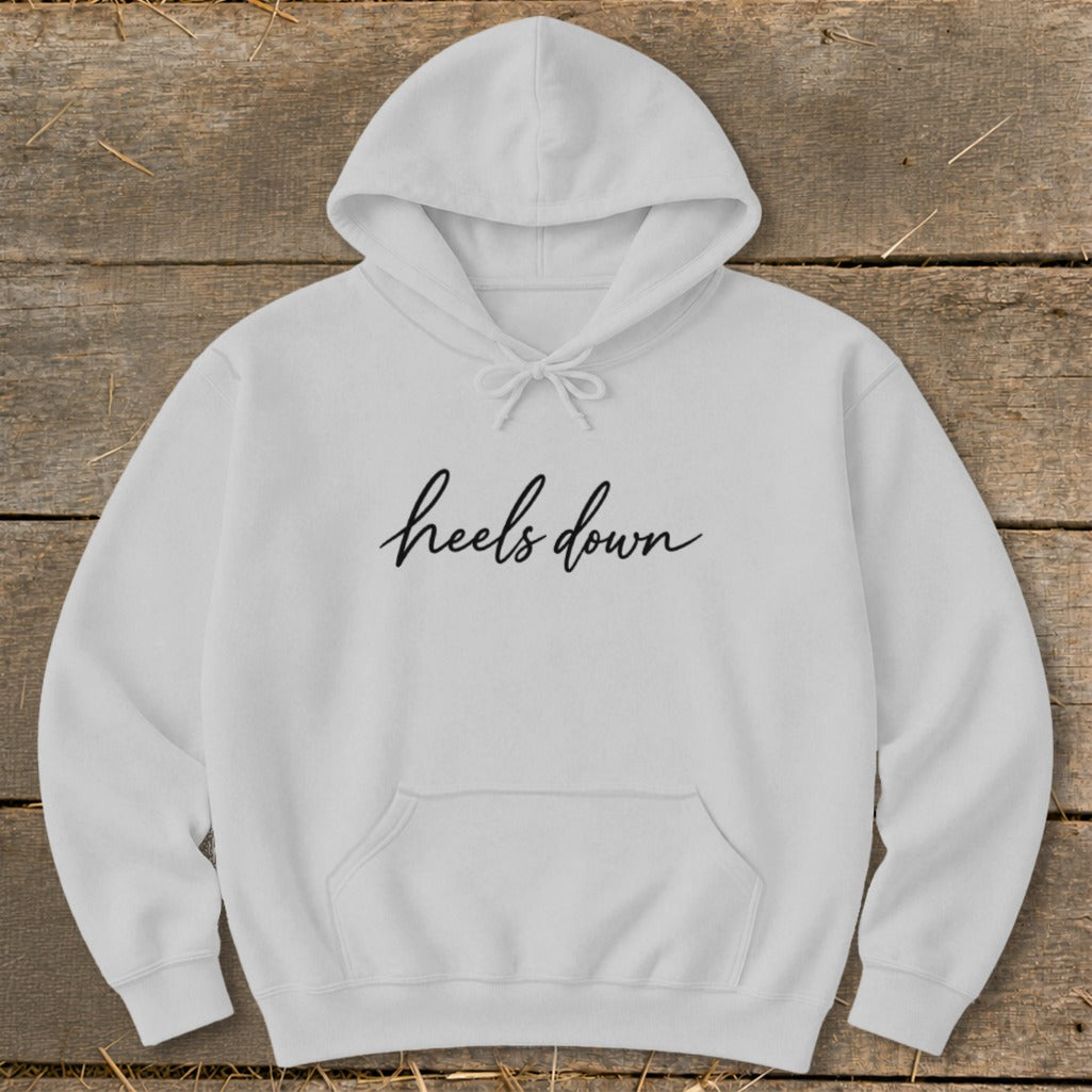White hoodie with black "heels down" text across the chest.