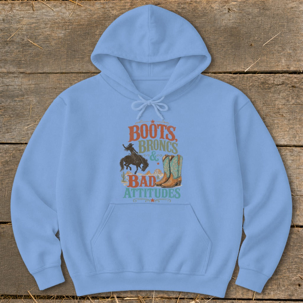 Light blue hoodie with graphic text "Boots Broncs & Bad Attitudes" and Western imagery.
