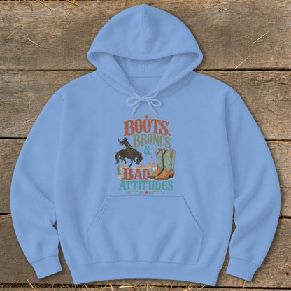 Light blue hoodie with graphic text "Boots Broncs & Bad Attitudes" and Western imagery.