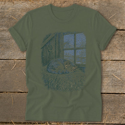 T-shirt with a sleeping cat on hay next to a window with snow.
