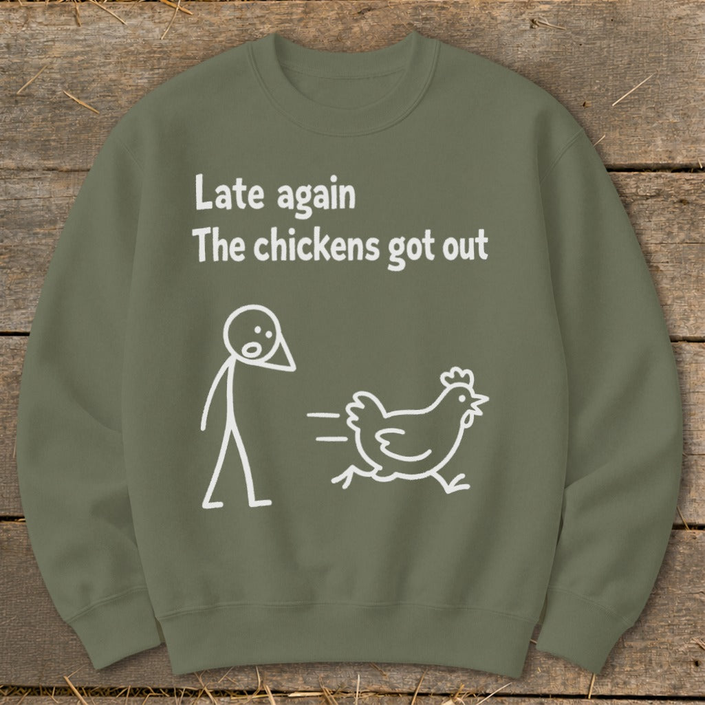 Green sweatshirt with text "Late again the chickens got out" and a stick figure chasing a chicken.