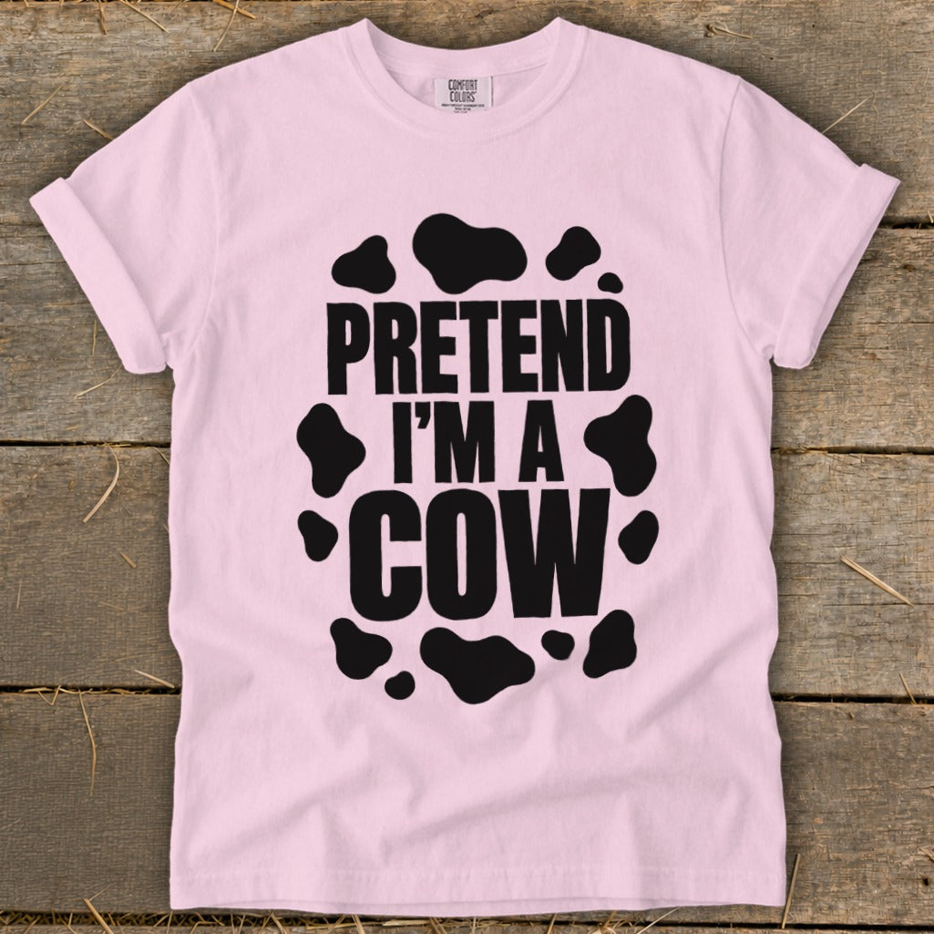 Pink t-shirt with black cow spots and text "PRETEND I'M A COW".